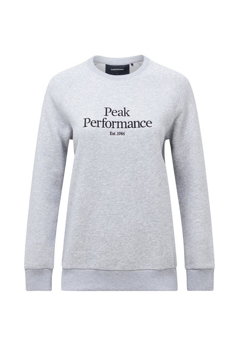 Hellgrauer Sweatshirt mit langen Raglanärmeln. Auf der Vorderseite befindet sich schwarzer Text "Peak Performance Est.1986". Weicher Stoff, gerippte Bundabschlüsse.