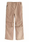 Beige, leichte, weit geschnittene Hosen mit elastischem Bund, zwei seitlichen Taschen und glatter Textur, geeignet für die Freizeit.