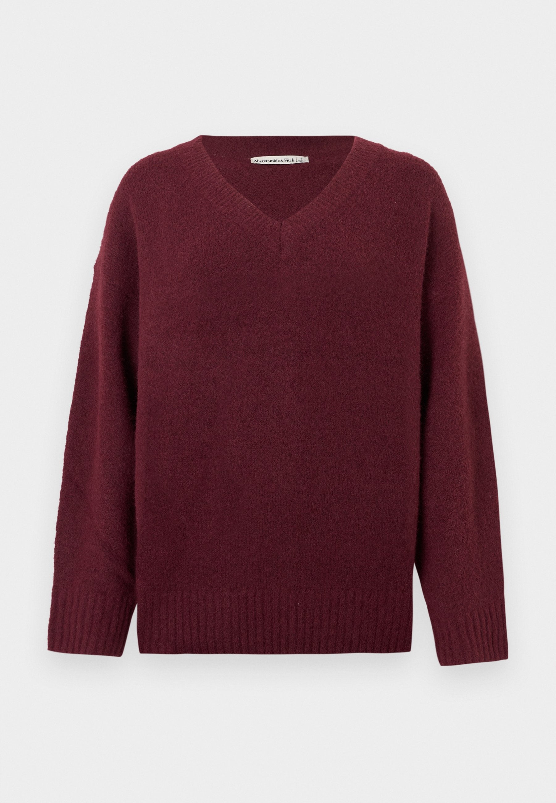 Weinroter V-Ausschnitt-Pullover aus weichem, strukturiertem Material mit weiten Ärmeln und geripptem Saum. Einfaches, klassisches Design ohne Verzierungen.
