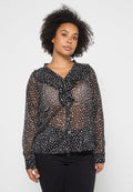 Schwarze durchsichtige Bluse mit rüschigem Kragen, die ein dezentes weißes und beiges abstractes Muster aufweist, sowie langen Ärmeln mit geknöpften Manschetten.