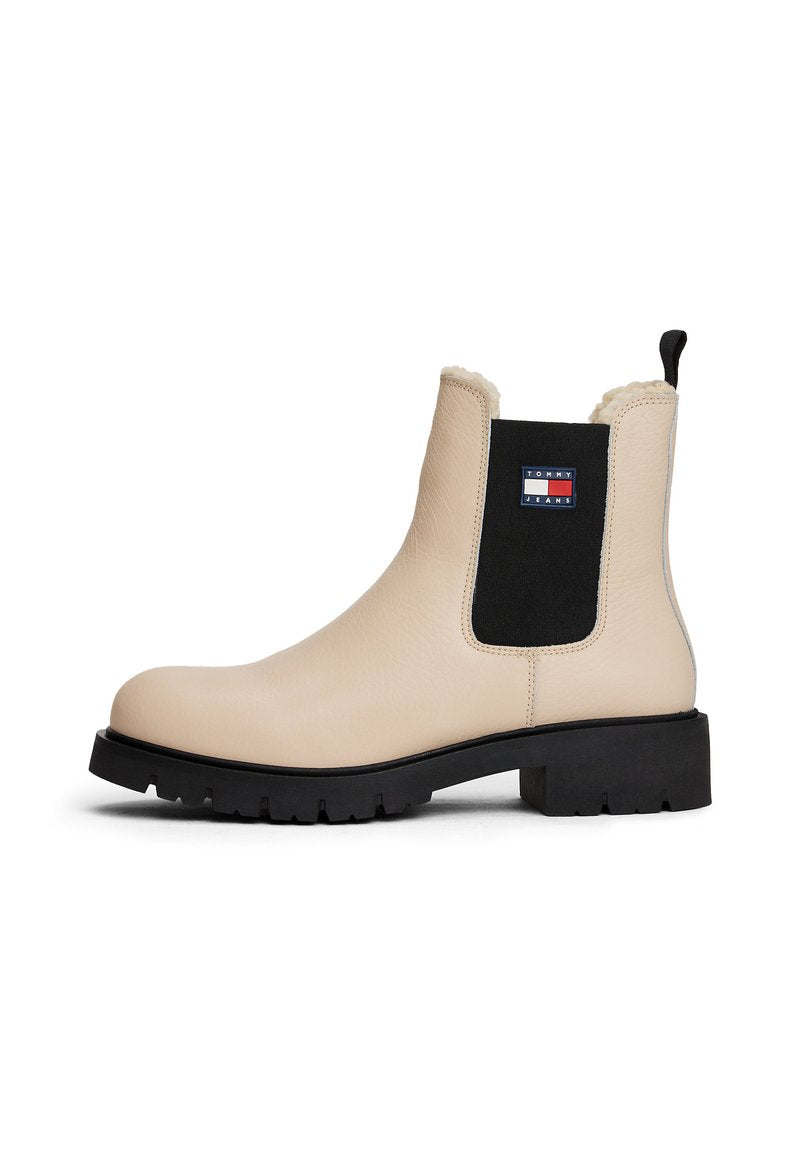 Beige Leder Chelsea-Stiefel mit schwarzem elastischen Seitenpanel, Tommy Jeans-Logo, Fleece-Futter, schwarzer chunky Sohle und Zugschlaufe hinten.