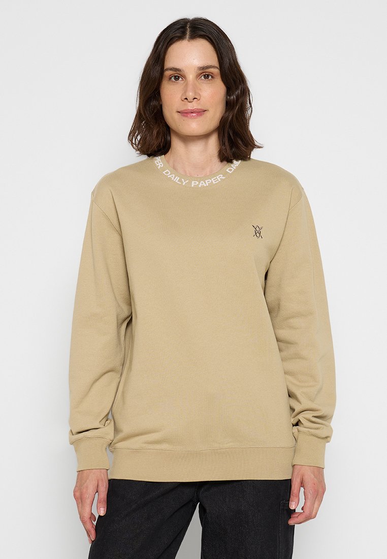 Beiger Sweatshirt mit Rundhalsausschnitt, langen Ärmeln und gerippten Bündchen. Mit dem weißen Text "DAILY PAPER" entlang des Ausschnitts und einem kleinen Logo auf der Brust.