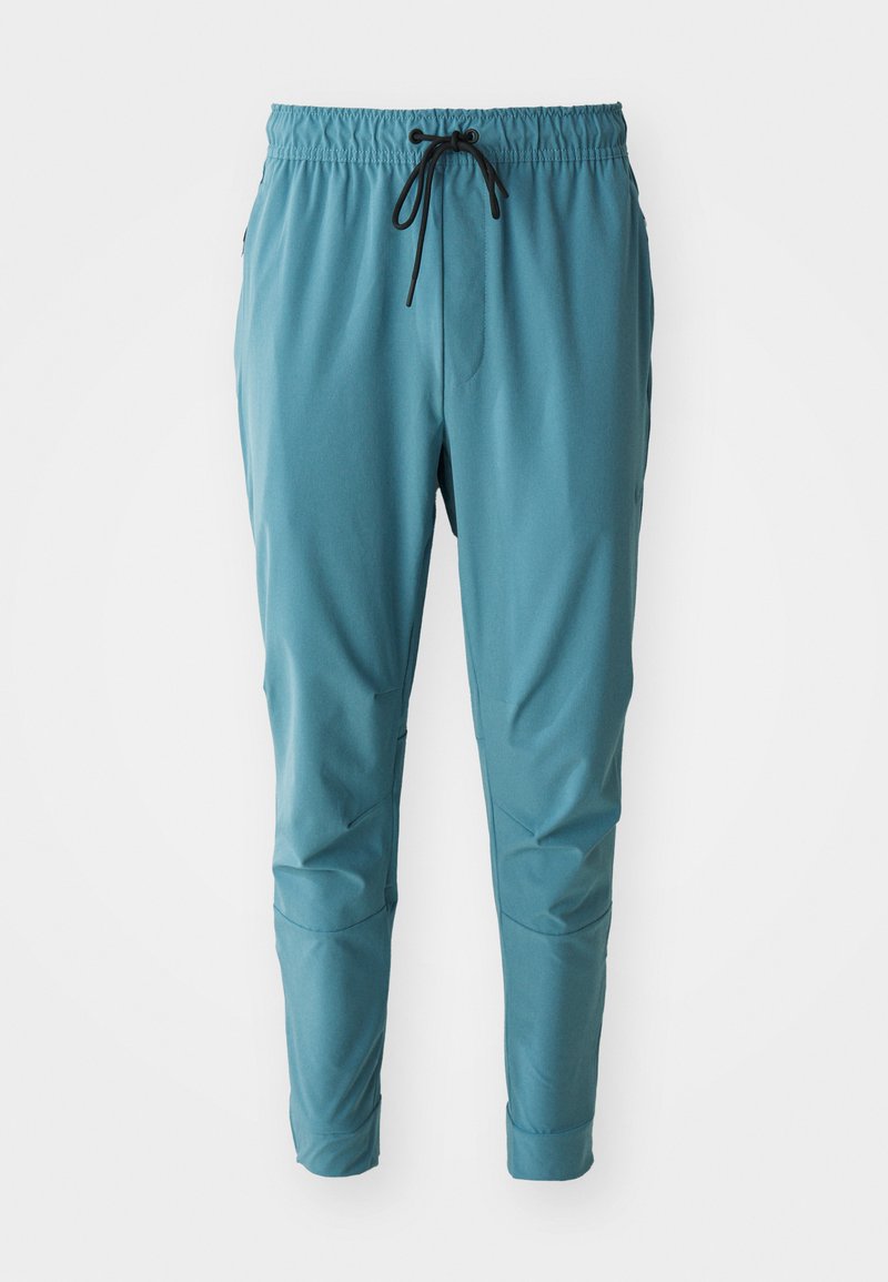 Hellblaue, schmal zulaufende Jogginghosen mit einem elastischen Bund, schwarzem Kordelzug, seitlichen Taschen und strukturierter Stoffoberfläche.