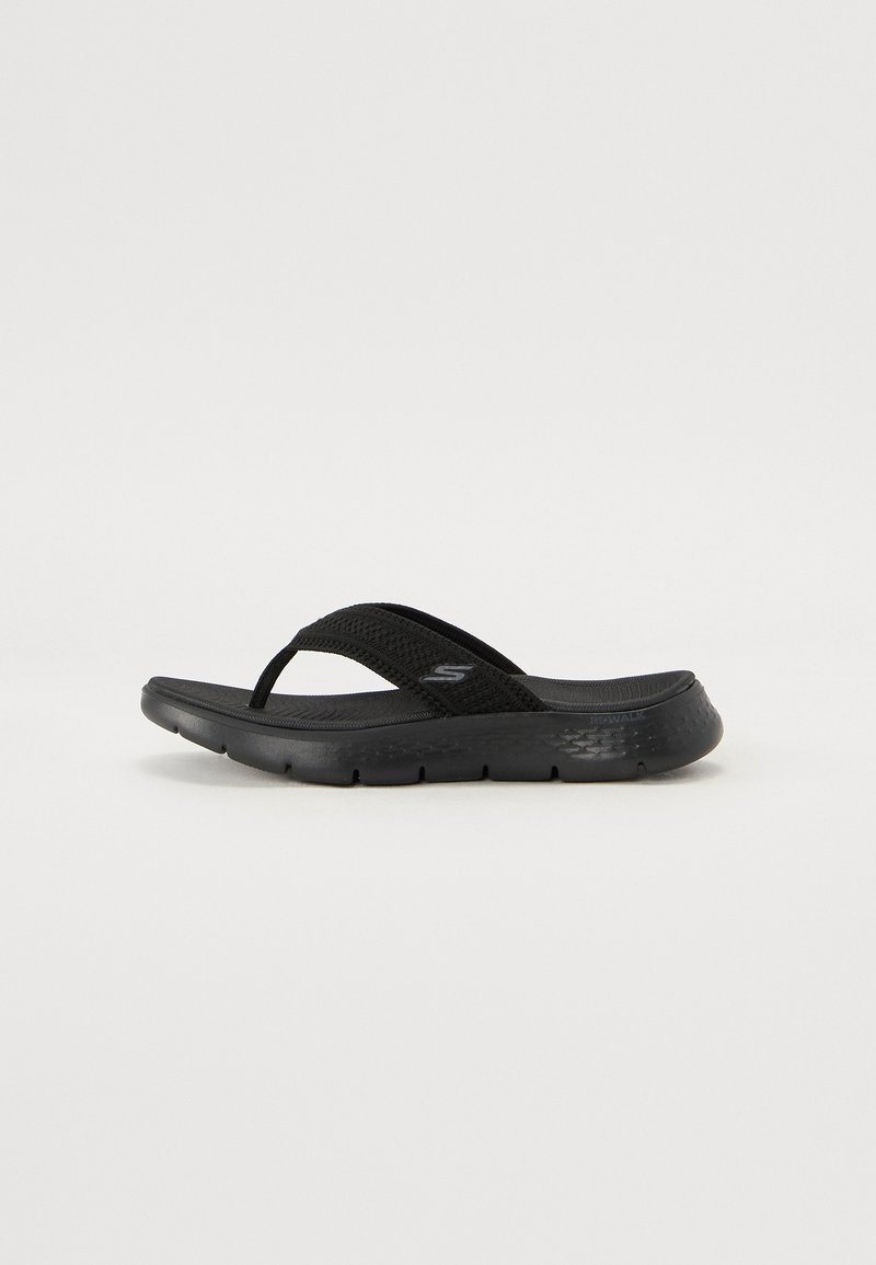 Schwarze Flip-Flop-Sandale mit einem strukturierten Obermaterial aus Synthetik, gedämpfter Sohle und dünnen Riemen für einen sicheren Halt. Leichtes Design.