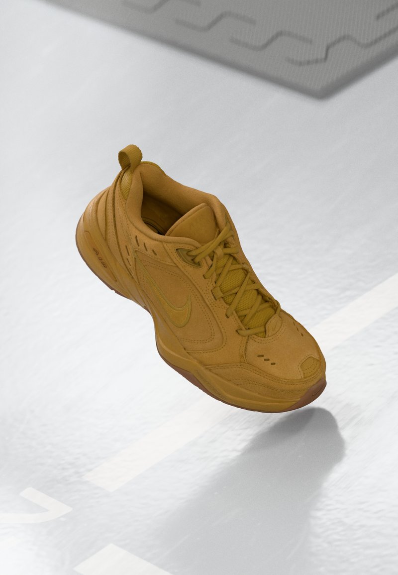 Brauner Nike-Sneaker, der in der Luft schwebt, mit sichtbarem Air-Sohlensystem und Schnürsenkeln, vor einer reflektierenden Oberfläche mit weißen Linien.