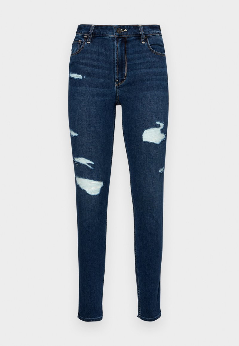 Dunkelblaue Skinny Jeans aus Denim mit distressed Patches und fransigen Details. Klassisches Fünf-Taschen-Design und Reißverschluss.