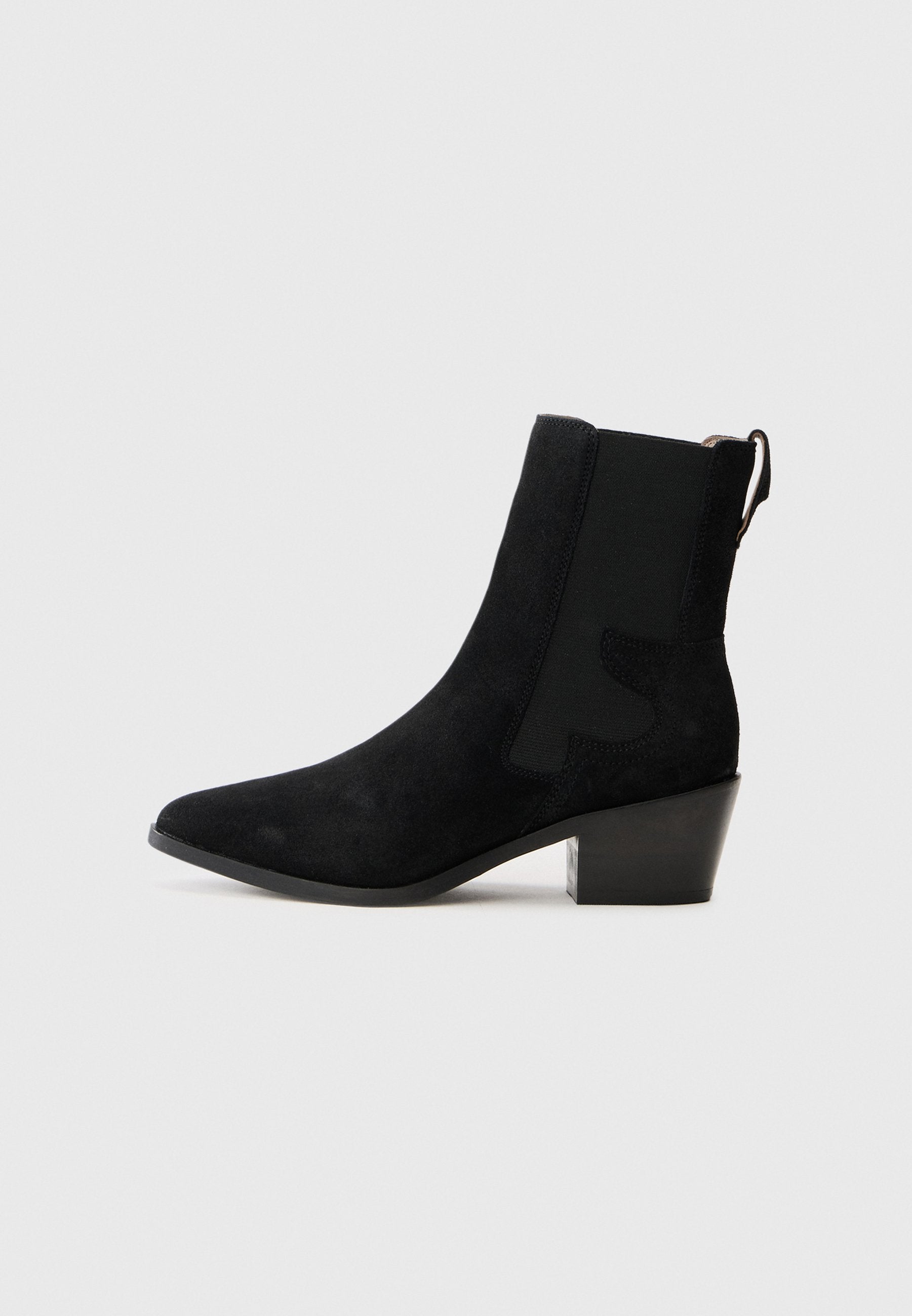 Schwarze Wildleder-Ankle-Boots mit spitzem Zehenbereich, elastischem Seitenpanel, Zugschlaufe und Blockabsatz auf einem schlichten weißen Hintergrund.