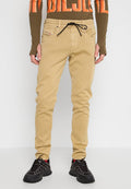 Beige Baumwollhose mit schmaler Passform, ausgestattet mit einem elastischen Kordelzugbund, Seitentaschen und einer strapazierfähigen Stofftextur.