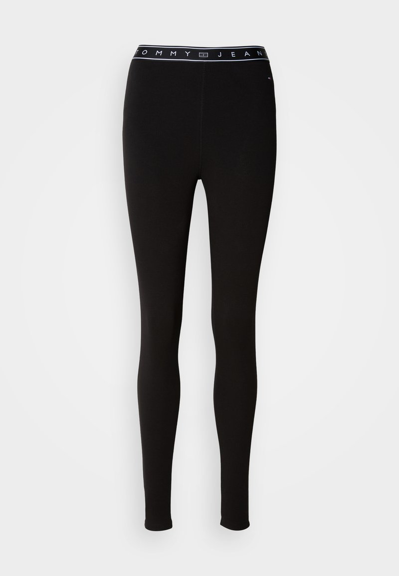 Schwarze Leggings aus elastischem Material mit einem Markenbund, auf dem "TOMMY JEAN" in weißem Text steht. Entworfen mit einer figurbetonten Silhouette.