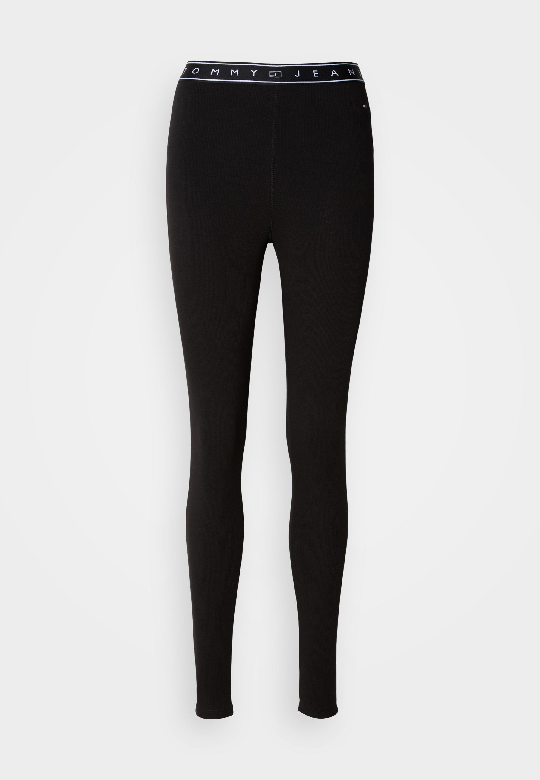 Schwarze Leggings aus elastischem Material mit einem Markenbund, auf dem "TOMMY JEAN" in weißem Text steht. Entworfen mit einer figurbetonten Silhouette.