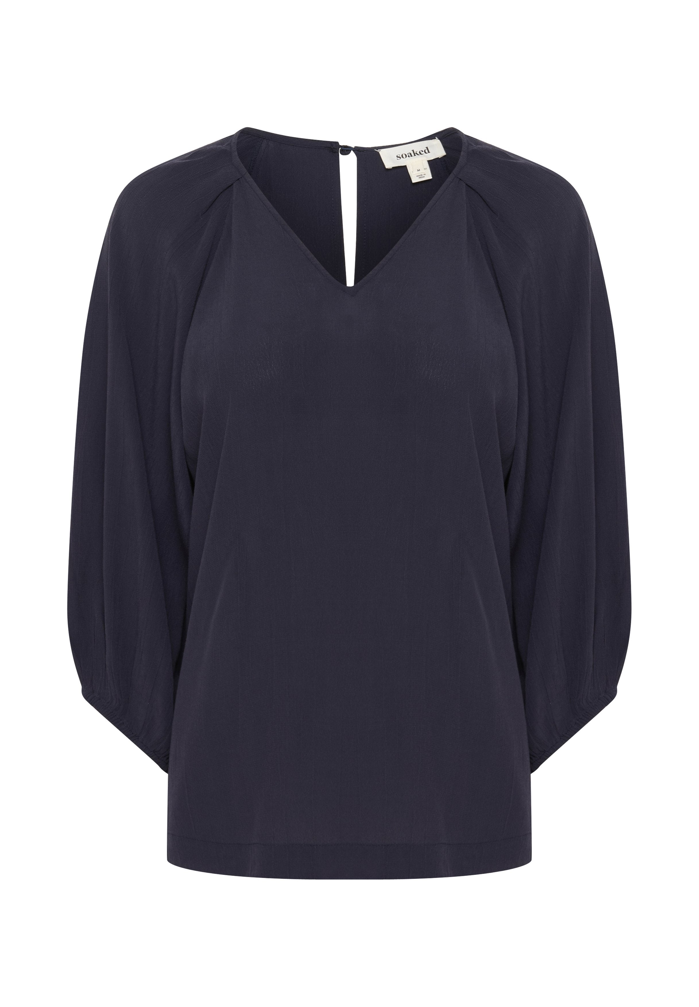 Marinebluse mit V-Ausschnitt, dreiviertellangen Puffärmeln und einem Schlüsselloch-Rückendetail. Hergestellt aus leichtem, glattem Stoff.