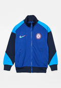 Blau- und schwarze Zip-Jacke für den Sport mit hellblauen Schulterpaneelen, Nike-Logo und Wappen des Chelsea Football Clubs auf der Brust.