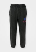 Schwarze Sweatpants mit strukturiertem Finish, ausgestattet mit einem Kordelzugbund, seitlichen Streifen und einem bunten Grafikdesign am linken Oberschenkel.