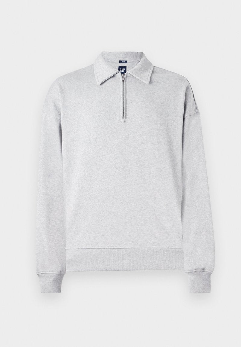 Grauer Sweatshirt mit einem halben Reißverschluss-Kragen, langen Ärmeln und gerippten Bündchen sowie Saum. Hergestellt aus weichem, strukturiertem Stoff. Einfaches, unaufgeregtes Design.