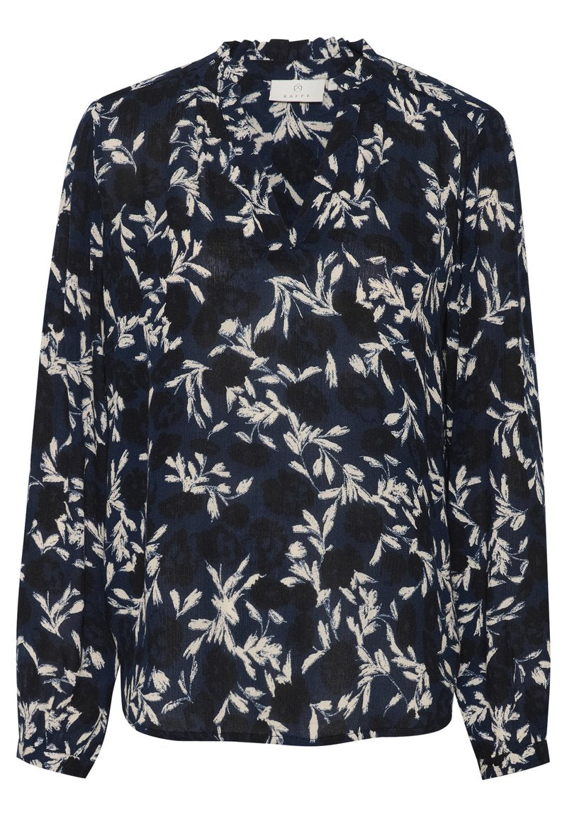 Langärmlige Bluse in Marineblau mit floralem Druck in Weiß. Verfügt über einen rüschengesäumten Ausschnitt und einen geraden Saum. Aus weichem, leichtem Stoff.