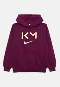 Burgunderfarbener Hoodie mit einer vorderen Kängurutasche, gerippten Bündchen und einem großen beigen Logo mit "KM" und dem Nike-Swoosh auf der Brust.