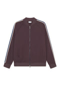 Burgunderrote Trainingsjacke mit durchgehendem Reißverschluss, Raglanärmeln, seitlichen Taschen und kontrastierenden Streifen in Beige und Blau an den Schultern.