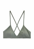 Grüne gerippte Bralette mit tiefem Ausschnitt und überkreuztem Trägerdesign. Weiches, elastisches Gewebe mit glatter Textur.