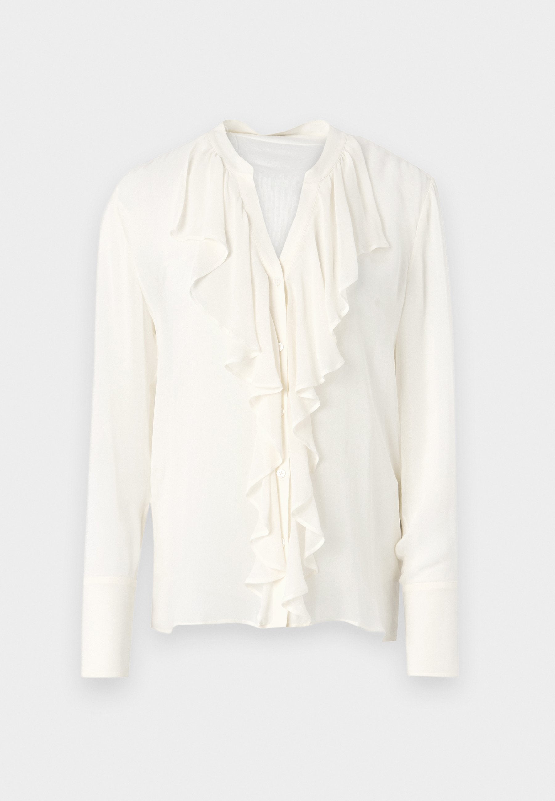 Weiße Bluse mit langen Ärmeln und einem gerafften Vorderteil, rundem Halsauschnitt und Knopfleiste. Aus weichem, leichtem Material.