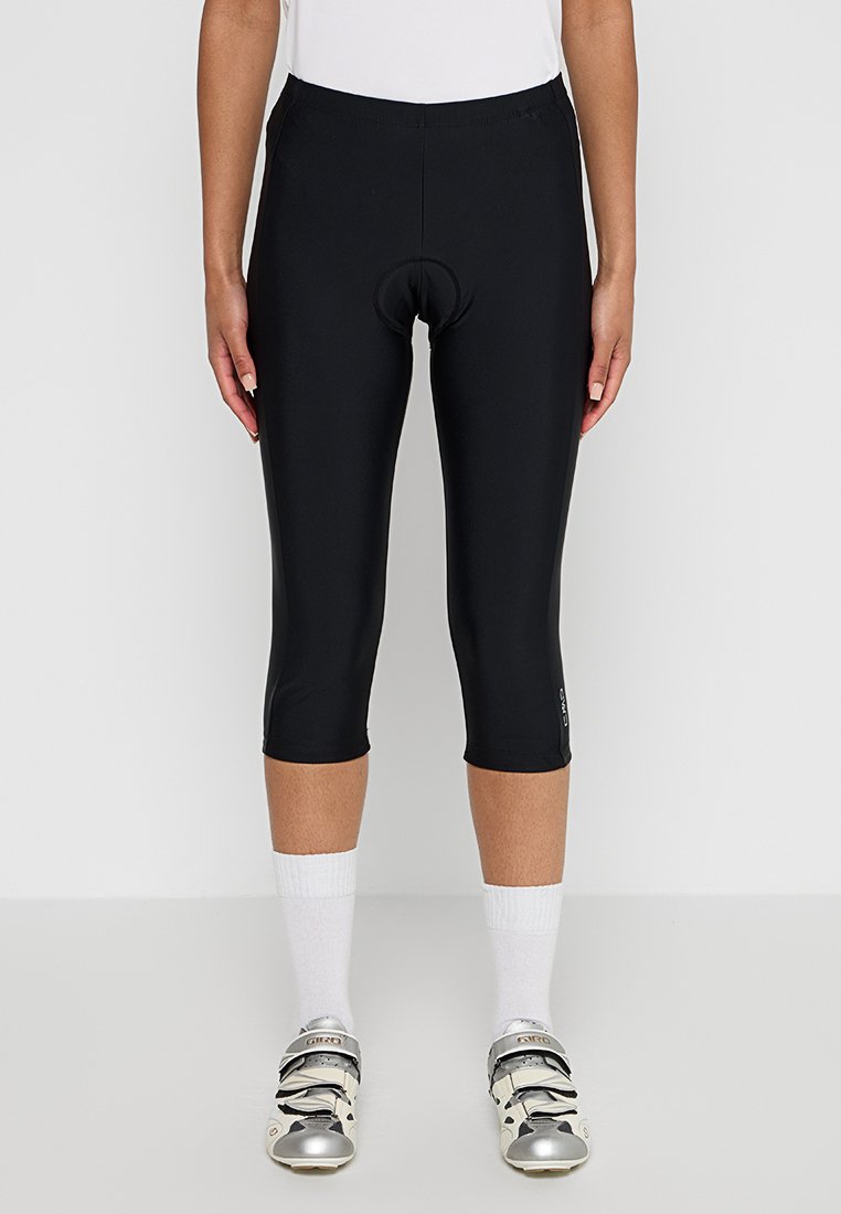 Schwarze Radshorts aus dehnbarem Material, mit knielangem Design und gepolstertem Bereich für zusätzlichen Komfort. Verfügt über eine figurnahe Silhouette.