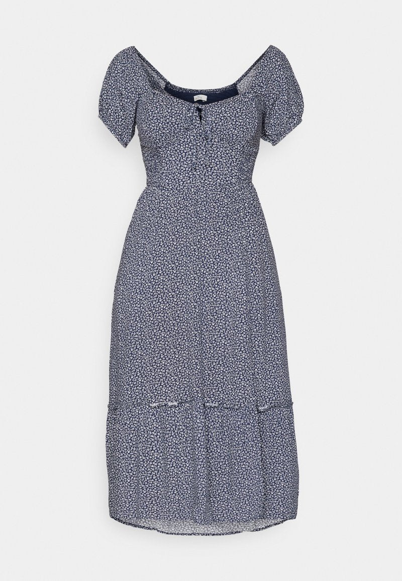 Marineblaue Blume Kleid mit kurzen Puffärmeln, einem quadratischen Ausschnitt und einer Knopfdetaillierung an der Vorderseite. Verfügt über ein gestuftes Rockdesign.