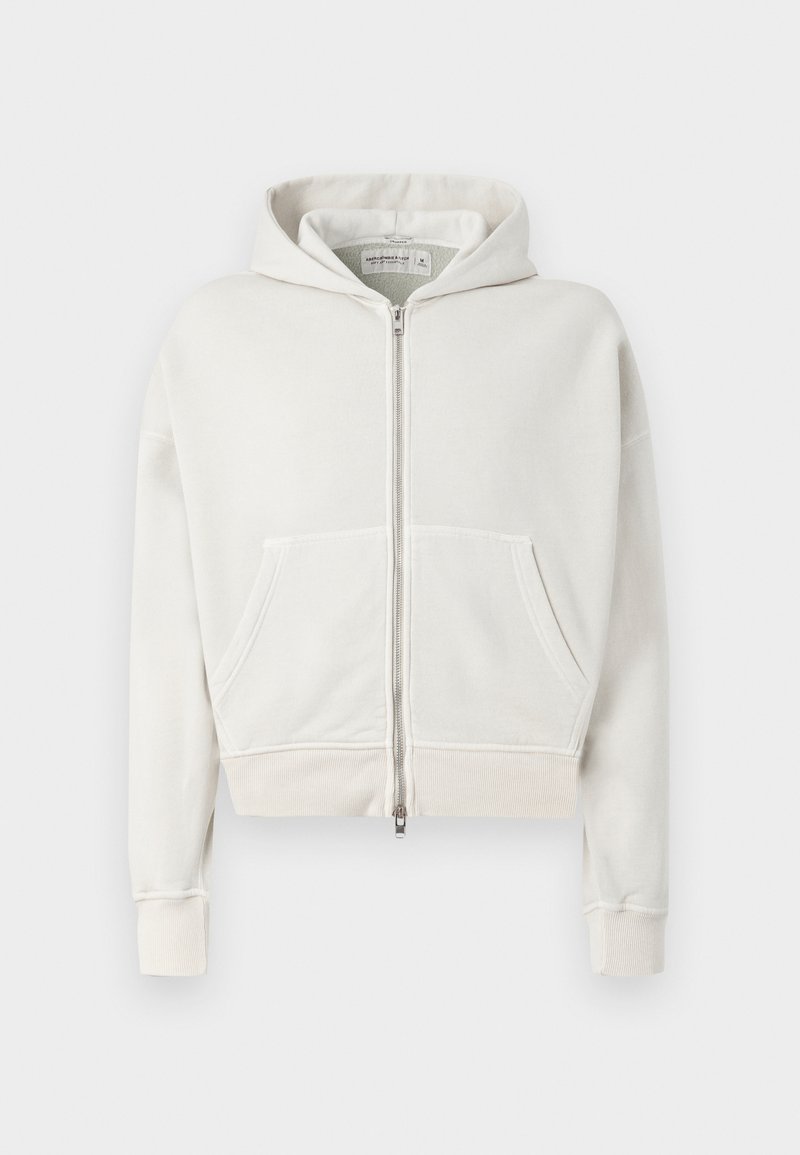 Hellgrauer, taillierter Hoodie aus weicher Baumwolle. Mit durchgehendem Reißverschluss, zwei Fronttaschen, gerippten Bündchen und einer Kapuze mit Kordelzug.