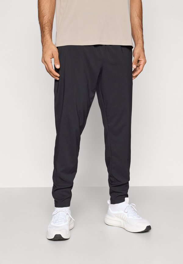 Under Armour VANISH TRAINING - Tracksuit bottoms - black/white