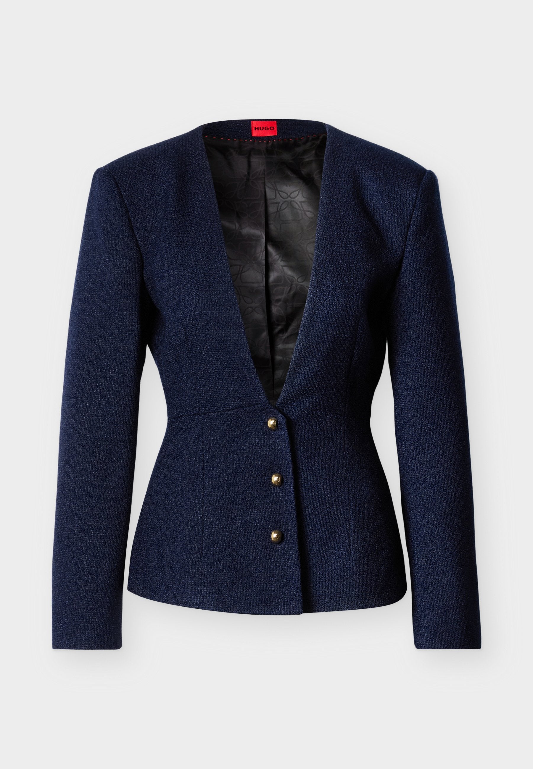 Marineblauer, strukturierter Blazer mit langen Ärmeln, tiefem V-Ausschnitt und drei goldenen Knöpfen. Innenfutter aus schwarzem Stoff mit geometrischem Muster.