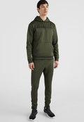 Olivgrünes Hoodie- und Jogginganzug-Set aus glattem Stoff. Mit einer Fronttasche und Logo-Text, sowie eng anliegenden Bündchen und Taillenbund. Schwarze Sneaker.