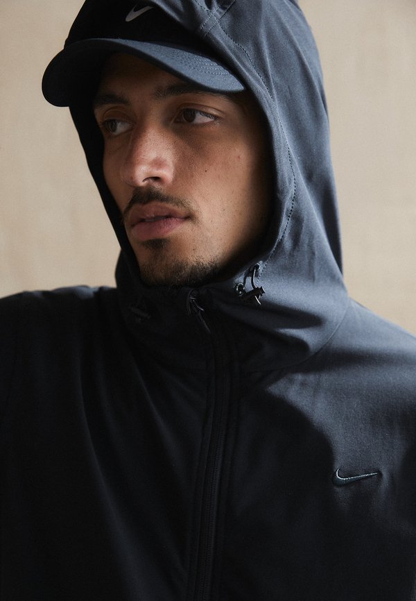 Nike Performance UNLIMITED - Windbreaker - black