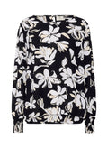 Schwarze Bluse mit weißem Blumenmuster, langen Ärmeln mit gerafften Manschetten, rundem Ausschnitt und leicht durchscheinendem Stoff.