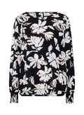 Schwarze Bluse mit weißem Blumenmuster, langen Ärmeln mit gerafften Manschetten, rundem Ausschnitt und leicht durchscheinendem Stoff.