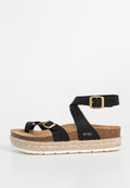 Schwarze Plattformsandalen mit breiten Riemen, Goldbuckle-Akzenten und einem Korkfußbett. Die Sohle verfügt über ein gewebtes Jute-Design für Struktur.