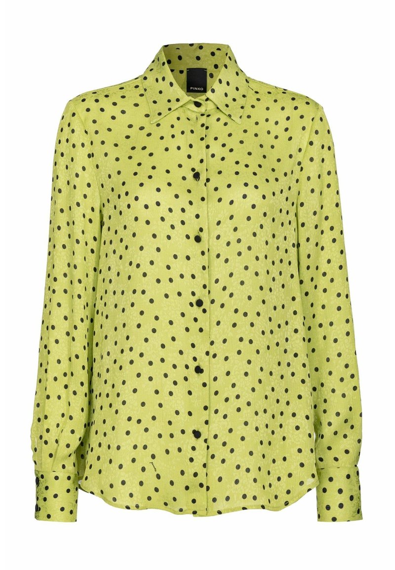 Grüne langärmelige Bluse mit Knopfkragen, aus strukturiertem Stoff mit schwarzen Punkten.