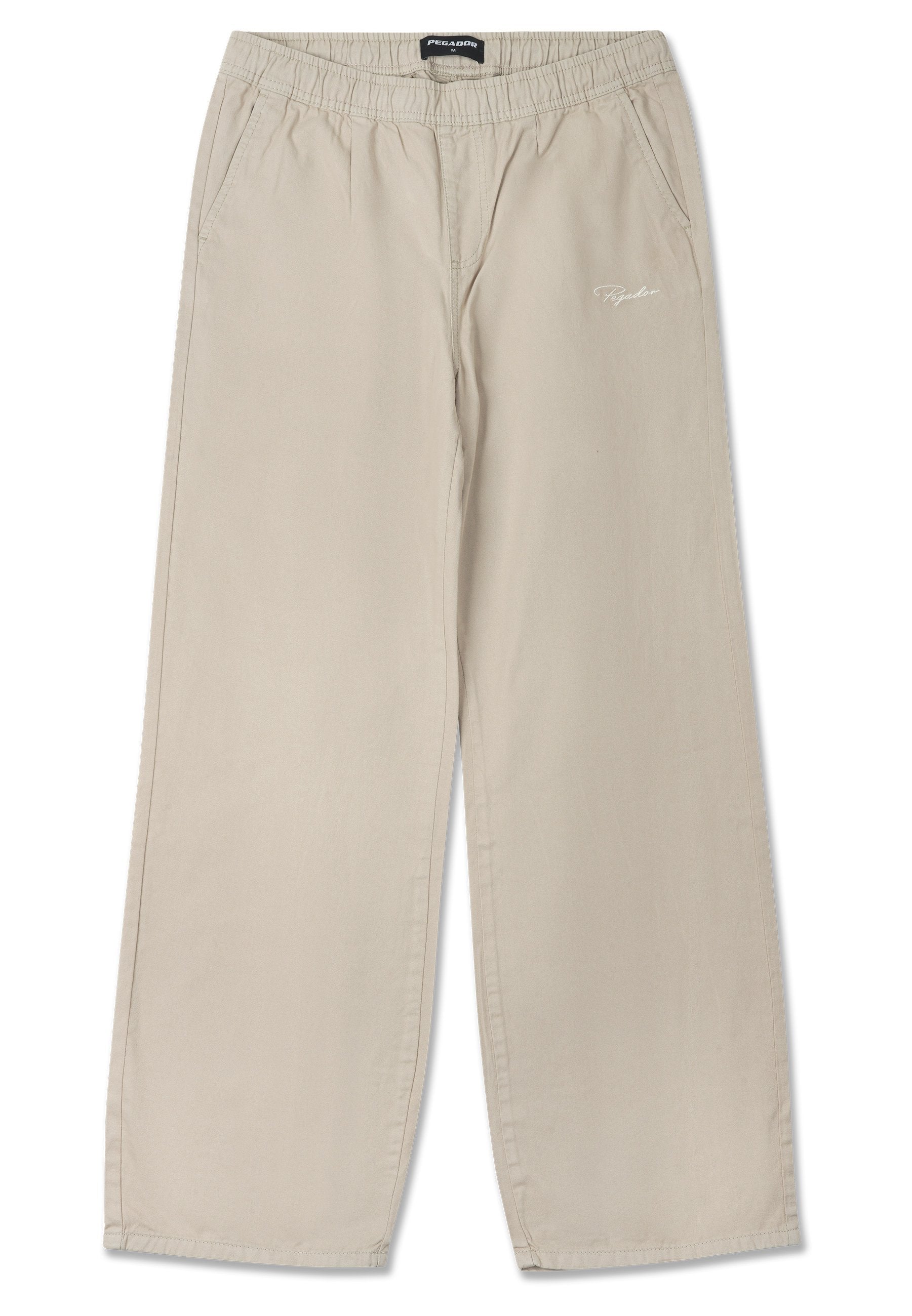 Beige weite Hosen mit einem elastischen Bund, seitlichen Taschen und gesticktem Logo auf der Vorderseite. Hergestellt aus weichem, leichtem Stoff.