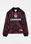 Schwarz-rotes langärmeliges Sporttrikot mit dem Schriftzug "CANADA", Ahornblattwappen, Nike-Logo und geometrischem Muster auf dem Stoff.