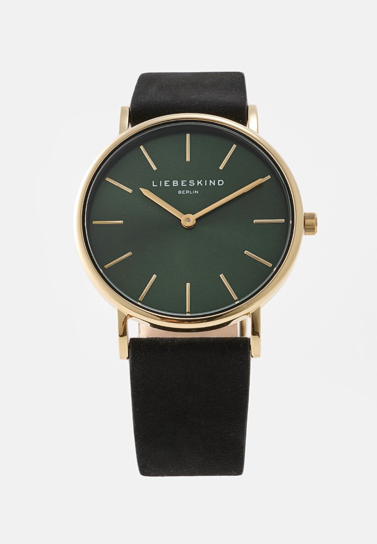 Runde Uhr mit einem Gehäuse aus goldfarbenem Metall, grünem mattem Ziffernblatt, goldenen Stundenmarkierungen und einem schwarzen Wildlederarmband. Verfügt über eine Krone zur Zeiteinstellung.