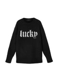 Schwarzer Pullover mit weicher Textur, der das Wort "lucky" in weißer, flauschiger Schrift auf der Vorderseite zeigt. Rundhalsausschnitt und lange Ärmel.
