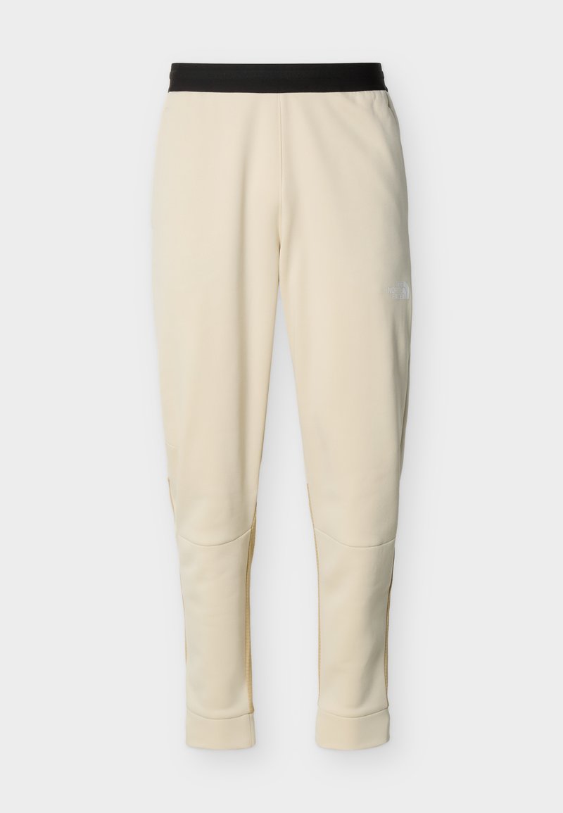 Cremafarbene, zuspitzende Hose mit schwarzem elastischem Bund und dezentem Logo am oberen linken Oberschenkel.