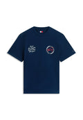 Marineblaues T-Shirt mit kurzen Ärmeln, weißer Stadtnamen auf der linken Brustseite und rundem Tommy Jeans-Logo mit roter Signatur auf der rechten Brustseite.