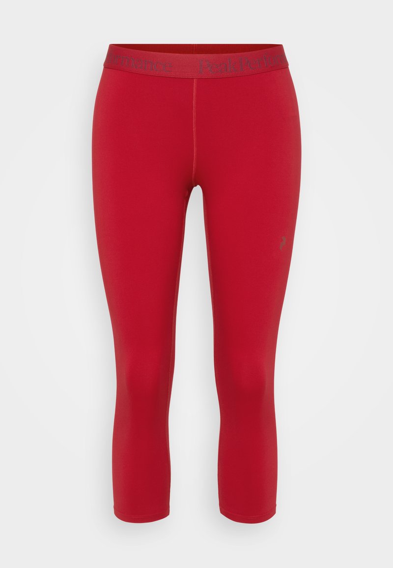 Rote, zugeschnittene Leggings mit glatter Textur, ausgestattet mit einem Logo-besetzten Bund aus kontrastierendem Material. Keine auffälligen Muster oder Akzente.