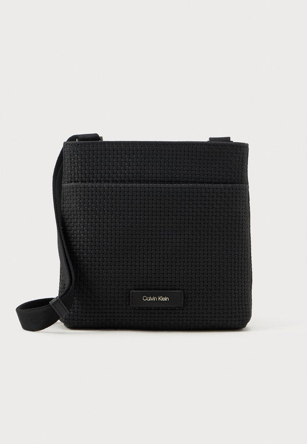 Calvin Klein EMBOSSED WOVEN FLATPACK - Cross body bag - black