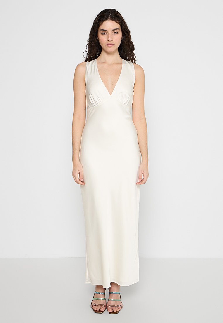 Cremfarbendes, ärmelloses Maxikleid mit tiefem V-Ausschnitt, glattem Satinmaterial und figurnaher Silhouette. Einfaches Design, keine sichtbaren Muster.