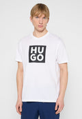 Weißes Baumwoll-T-Shirt mit einem quadratischen schwarzen Grafikdruck, auf dem das Wort "HUGO" in fetten weißen Buchstaben steht. Kurze Ärmel und Rundhalsausschnitt.