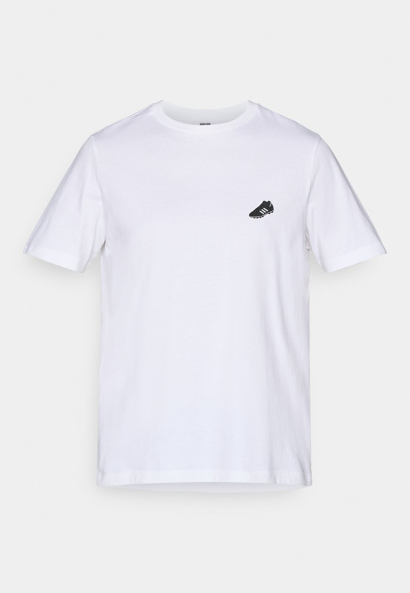 Weißes Baumwoll-T-Shirt mit kurzen Ärmeln und rundem Halsausschnitt; verfügt über eine kleine schwarze Fußballschuh-Grafik auf der linken Brust.