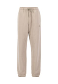 Beige Jogginghose aus weichem Material, mit einem Kordelzugbund, elastischen Bündchen und einem kleinen Logo an der Seite.