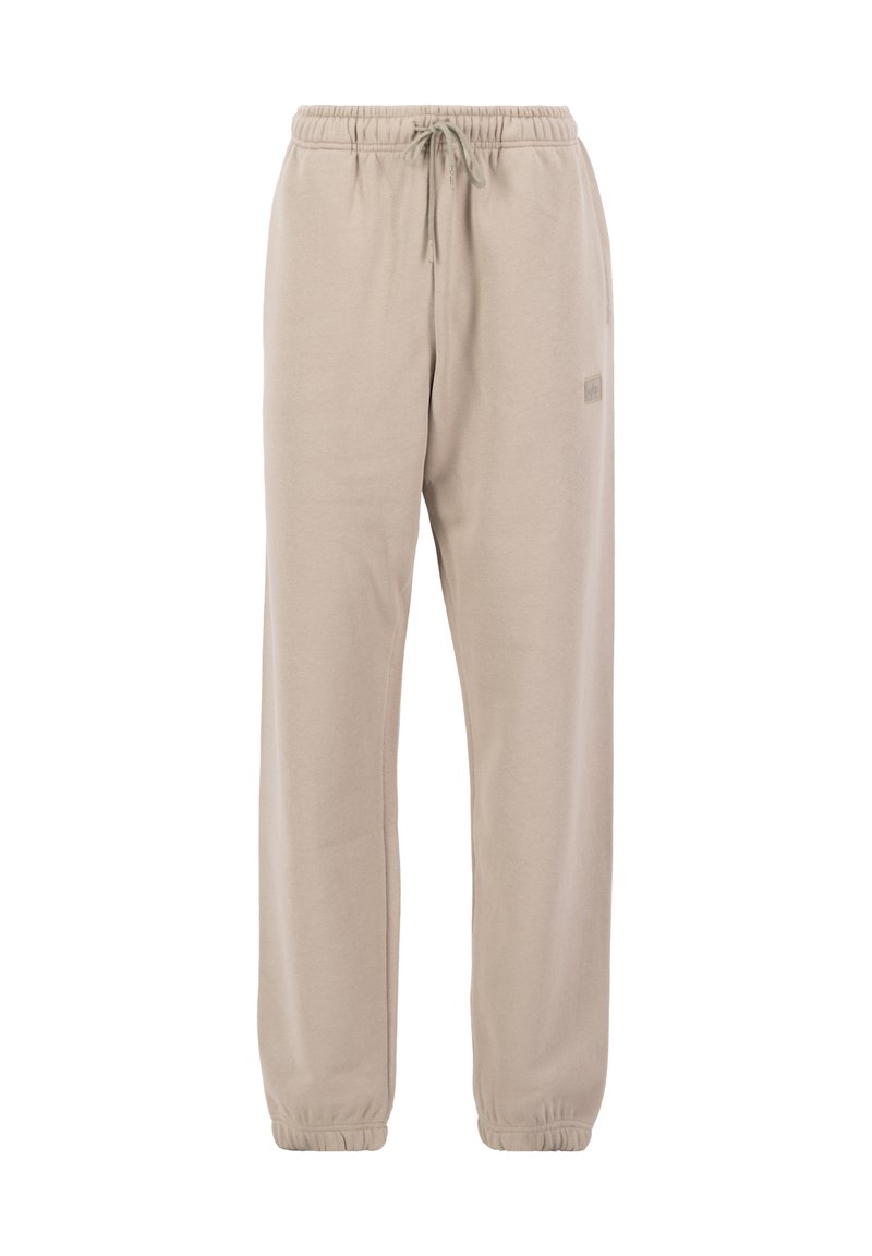 Beige Jogginghose aus weichem Material, mit einem Kordelzugbund, elastischen Bündchen und einem kleinen Logo an der Seite.