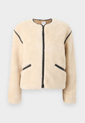 Beige Jacke aus Kunstpelz mit rundem Ausschnitt, Frontreißverschluss, schwarzen Akzenten an den Seiten und zwei Seitentaschen. Weiches, strukturiertes Material.
