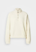 Cremefarbener Fleece-Pullover mit hohem Kragen, halbem Reißverschluss, lockerem Schnitt und gerippten Bündchen. Weiche Textur mit glattem Innenfutter.