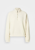 Cremefarbener Fleece-Pullover mit hohem Kragen, halbem Reißverschluss, lockerem Schnitt und gerippten Bündchen. Weiche Textur mit glattem Innenfutter.